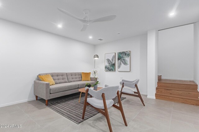 living room featuring light tile patterned floors and ceiling fan