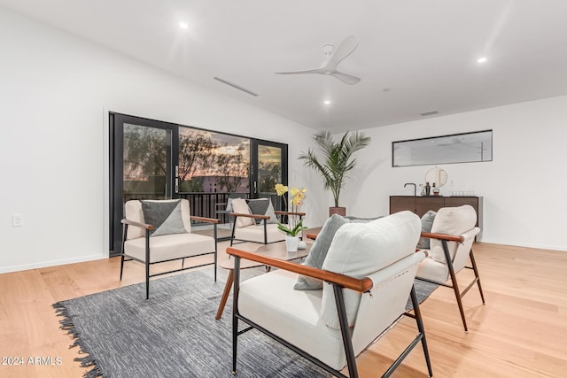 living area featuring ceiling fan and light hardwood / wood-style floors