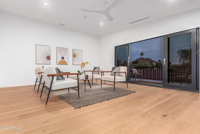 sitting room with light hardwood / wood-style floors and ceiling fan