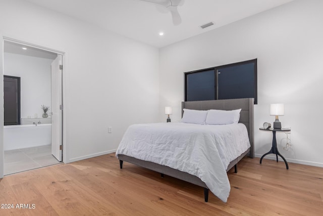 bedroom with connected bathroom, hardwood / wood-style floors, and ceiling fan