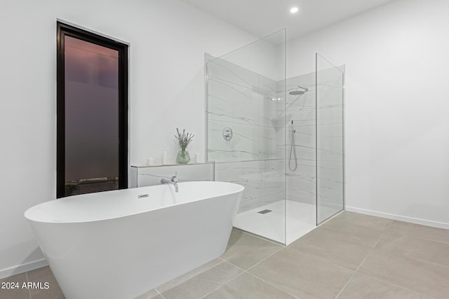 bathroom with separate shower and tub and tile patterned flooring