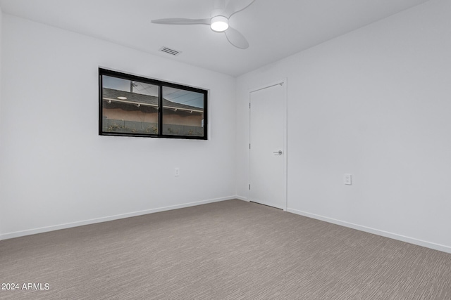 empty room featuring ceiling fan and carpet floors