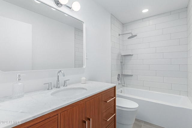 full bathroom featuring vanity, tile patterned flooring, tiled shower / bath combo, and toilet