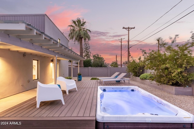 deck at dusk with area for grilling and an outdoor hot tub