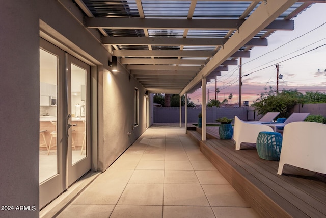 patio terrace at dusk featuring a pergola