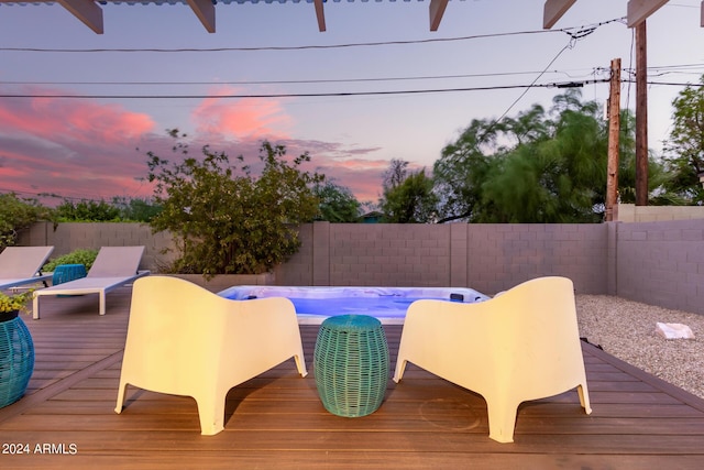 pool at dusk featuring a wooden deck