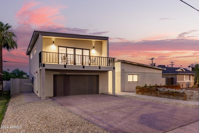 contemporary home featuring a balcony and a garage