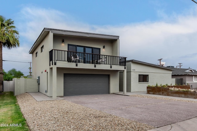 view of front of house featuring a garage and a balcony