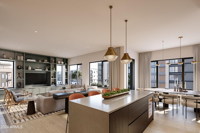 kitchen with light hardwood / wood-style floors, decorative light fixtures, and a kitchen island