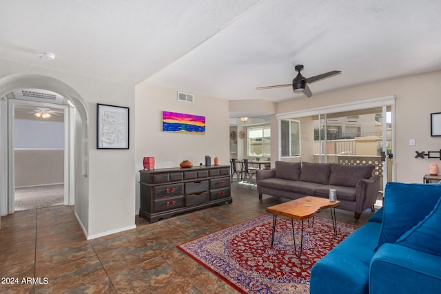 living room with a textured ceiling and ceiling fan