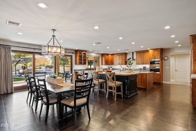 dining room featuring an inviting chandelier and sink