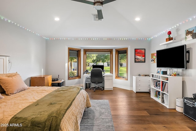 bedroom with ceiling fan, dark wood-type flooring, and vaulted ceiling