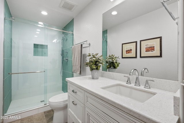 bathroom with tile patterned flooring, vanity, toilet, and a shower with shower door