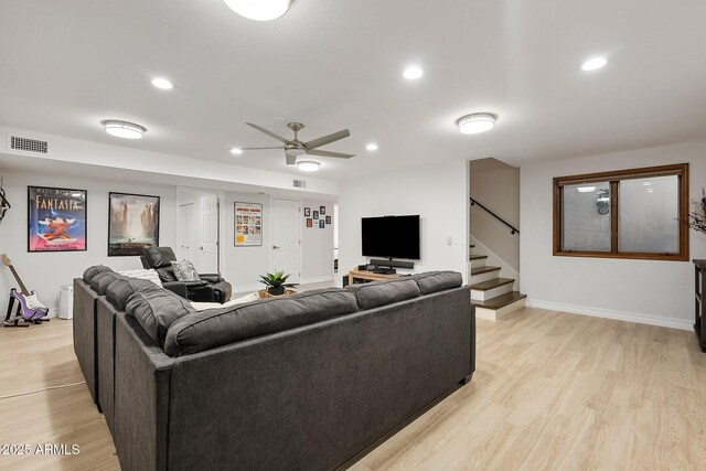 living room featuring light wood-type flooring and ceiling fan