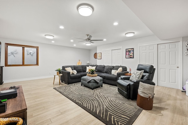 living room with ceiling fan and light hardwood / wood-style floors