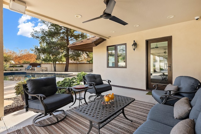 deck featuring a fenced in pool, ceiling fan, and a patio area