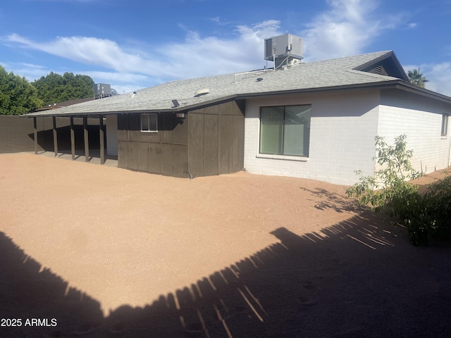 1452 E Emerald Ave, Mesa, AZ 85204 - rear view of house featuring roof with shingles and central AC