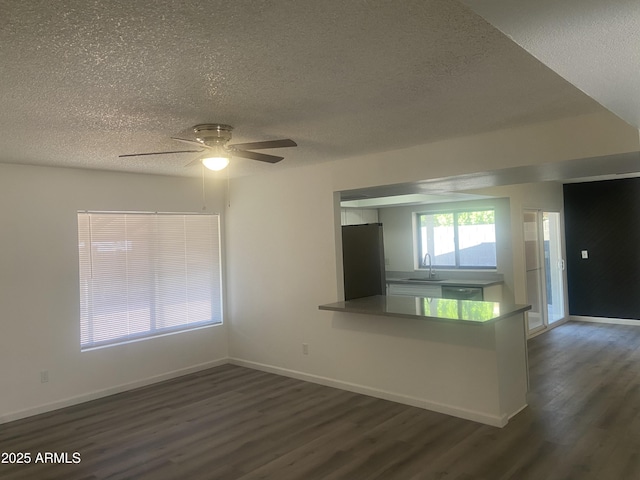 1452 E Emerald Ave, Mesa, AZ 85204 - unfurnished living room with a textured ceiling, a sink, dark wood-style floors, ceiling fan, and baseboards