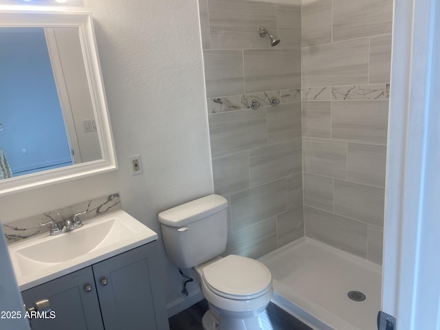 1452 E Emerald Ave, Mesa, AZ 85204 - bathroom featuring a tile shower, vanity, and toilet