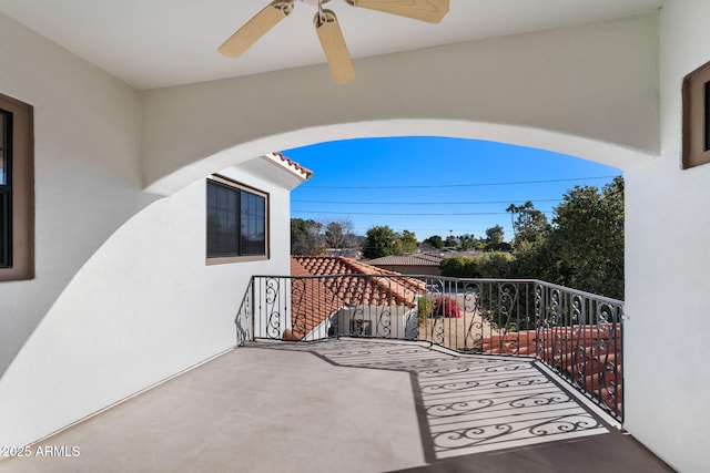 view of patio / terrace with a balcony and ceiling fan