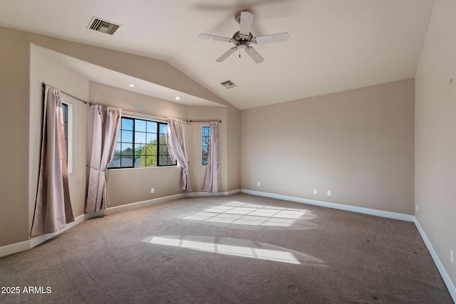 carpeted empty room featuring vaulted ceiling and ceiling fan