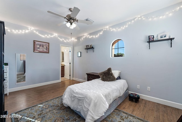 bedroom with ensuite bath, wood-type flooring, and ceiling fan