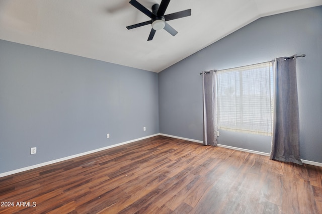 empty room featuring ceiling fan, vaulted ceiling, and dark hardwood / wood-style flooring