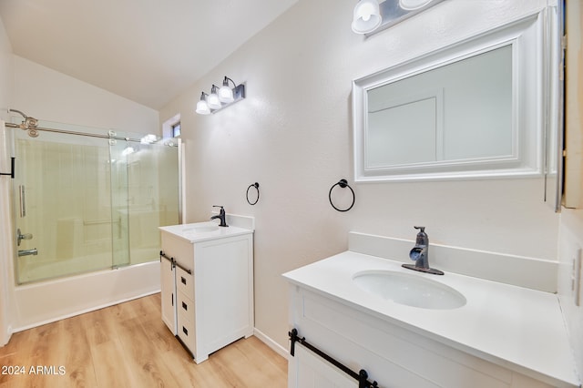 bathroom featuring shower / bath combination with glass door, vanity, lofted ceiling, and hardwood / wood-style floors