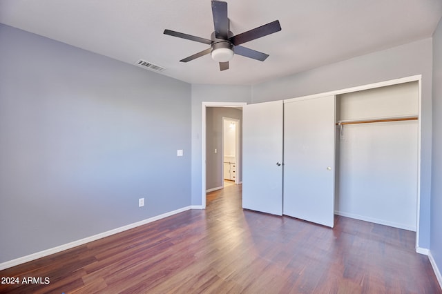 unfurnished bedroom with a closet, ceiling fan, and dark wood-type flooring