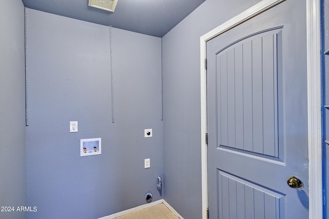 laundry area with washer hookup, hookup for an electric dryer, tile patterned flooring, and a textured ceiling