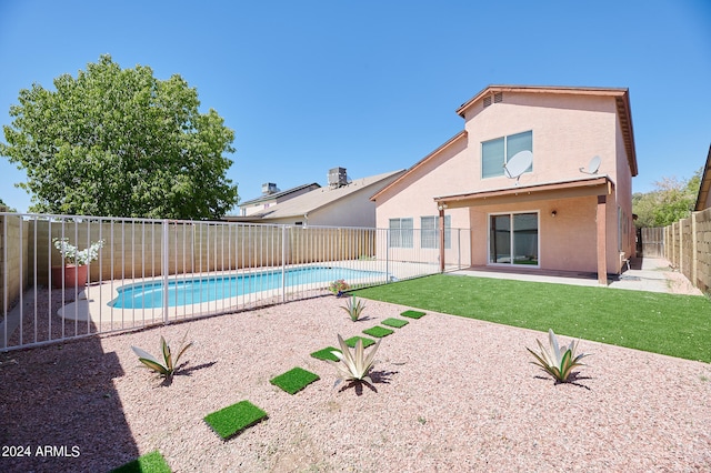 view of swimming pool with a patio and a lawn