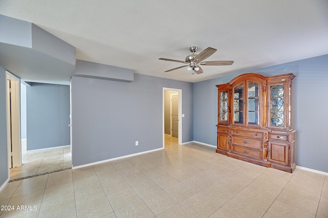 interior space featuring ceiling fan and a textured ceiling