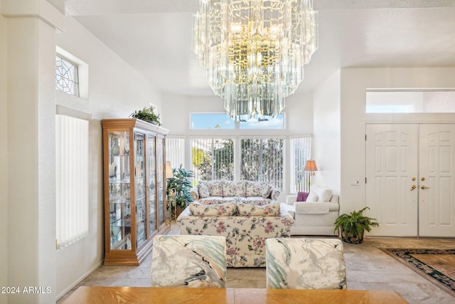 living area with a towering ceiling and an inviting chandelier