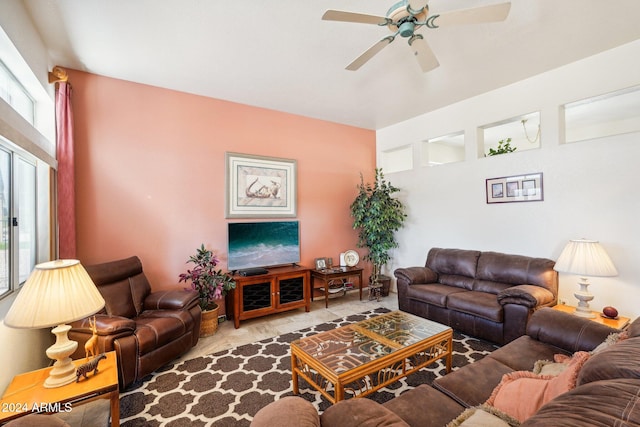 living area featuring carpet floors and a ceiling fan