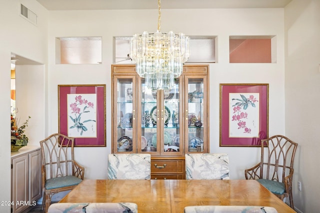 dining area featuring visible vents and a notable chandelier