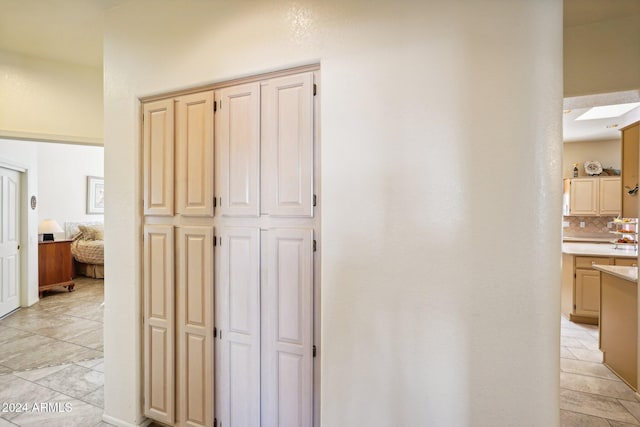 hallway featuring light tile patterned floors