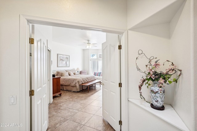 bedroom with light tile patterned floors and ceiling fan