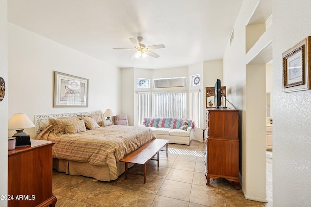 bedroom featuring visible vents, ceiling fan, and light tile patterned floors