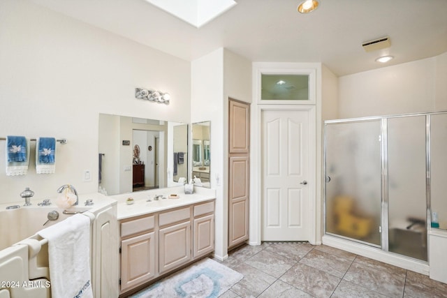 bathroom featuring vanity, a skylight, a shower stall, and a bath