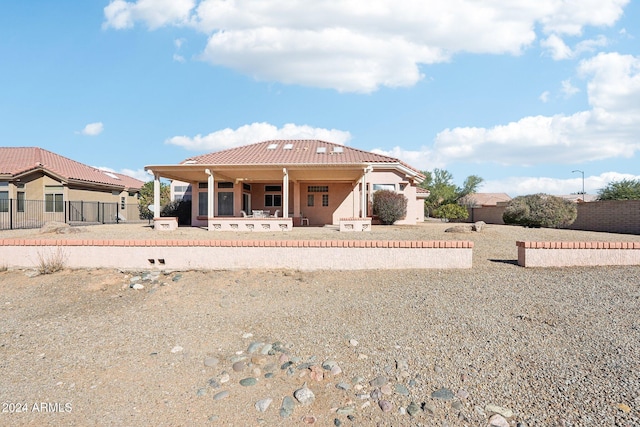 view of front of home featuring fence and a tiled roof