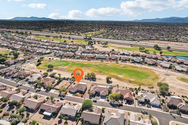 drone / aerial view with a residential view, a mountain view, and golf course view