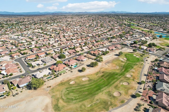 drone / aerial view with a residential view, a mountain view, and golf course view