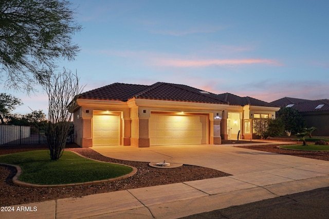 view of front facade with a garage, fence, a tile roof, driveway, and stucco siding