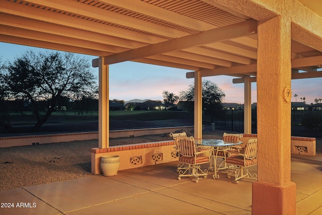 patio terrace at dusk with outdoor dining space