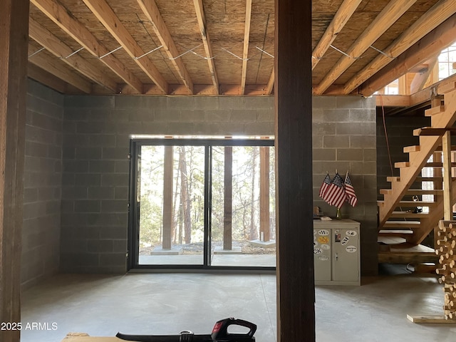 below grade area with stairway and concrete block wall