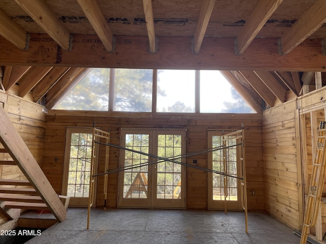 doorway to outside with french doors and wood walls