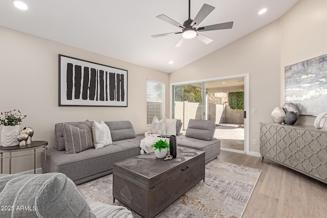 living room featuring ceiling fan, light hardwood / wood-style flooring, and high vaulted ceiling