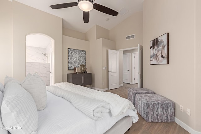 bedroom with ceiling fan, wood-type flooring, and lofted ceiling