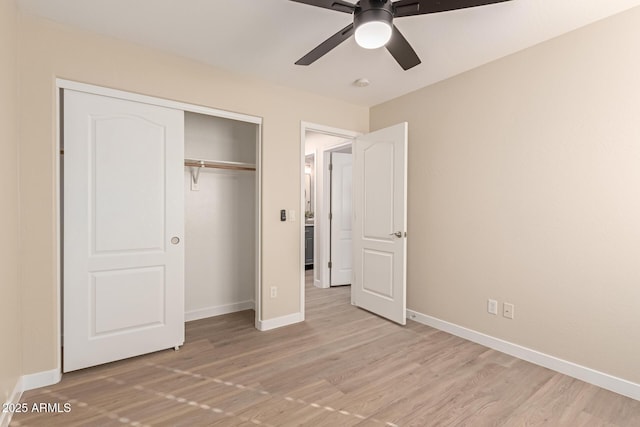 unfurnished bedroom with ceiling fan, a closet, and light hardwood / wood-style flooring