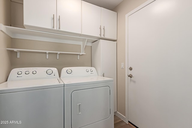 washroom featuring cabinets, dark hardwood / wood-style flooring, and independent washer and dryer